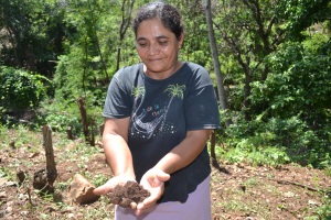 Guillarmina Castro with soil from her CA plot