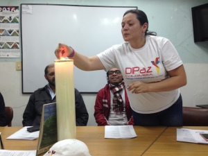 Angélica Rincón of MCC partner Justapaz lights a candle for peace. Photo courtesy Anna Vogt